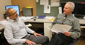 Drs. Greg DeMuri and James Conway comparing notes for a case.